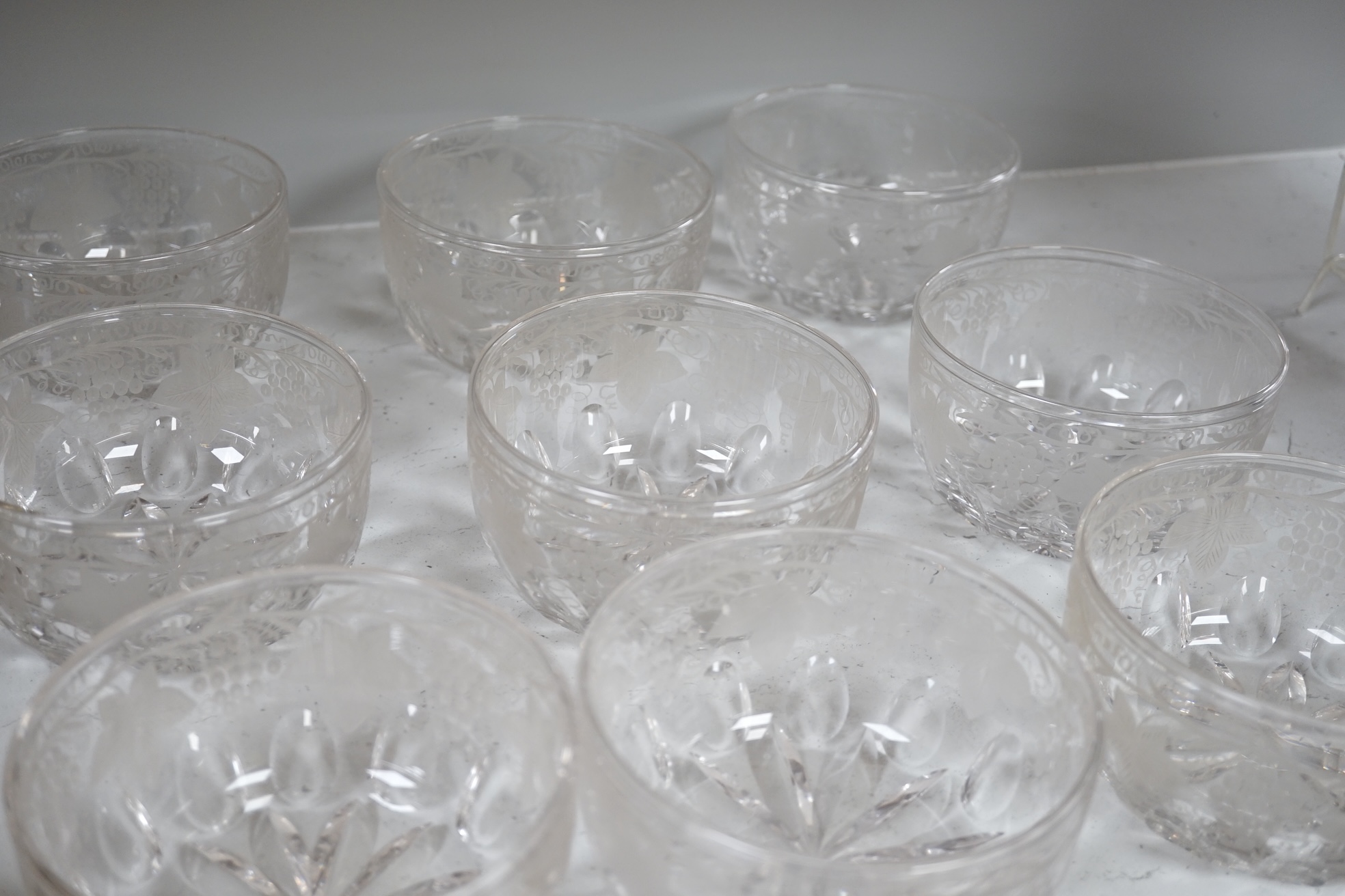 Nine vine engraved glass finger bowls, 13cm diameter. Condition - good.